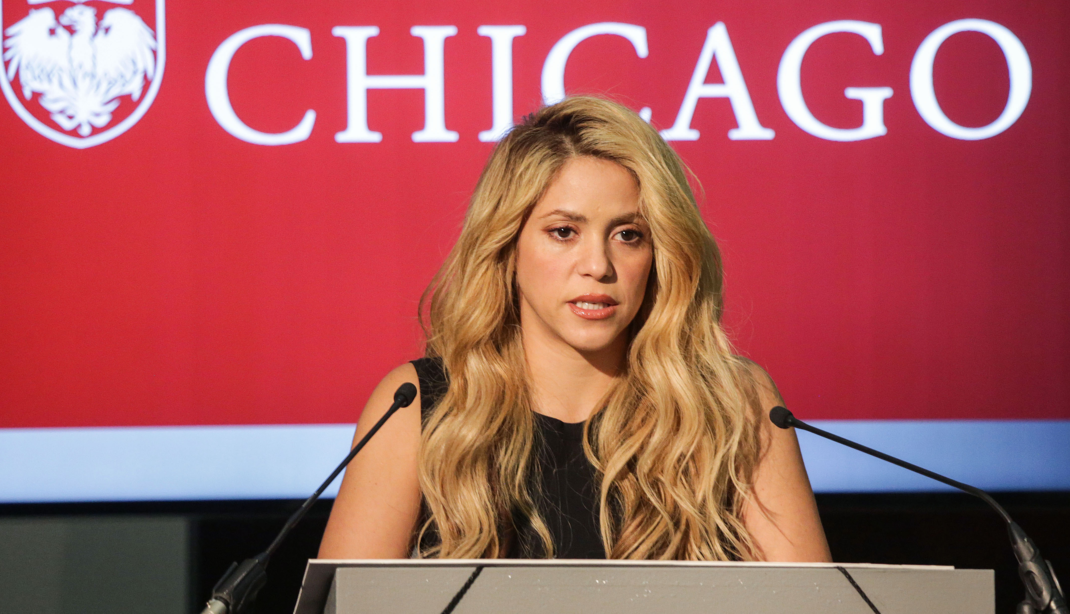 Shakira speaking at conference.