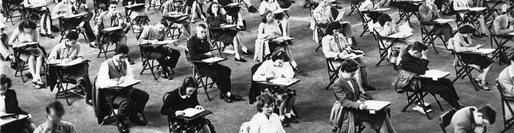 Old photo of students taking a test.